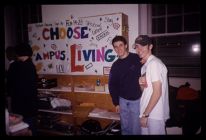 Students with "Choose Campus Living" sign